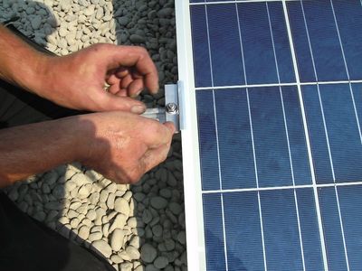 Hände montieren Solarmodul